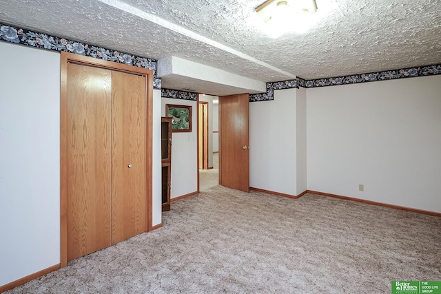 9706 N 51st St, Omaha, NE 68152 - unfurnished bedroom with carpet flooring, a closet, baseboards, and a textured ceiling