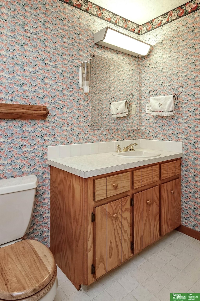 9706 N 51st St, Omaha, NE 68152 - bathroom featuring vanity, toilet, wallpapered walls, and tile patterned floors