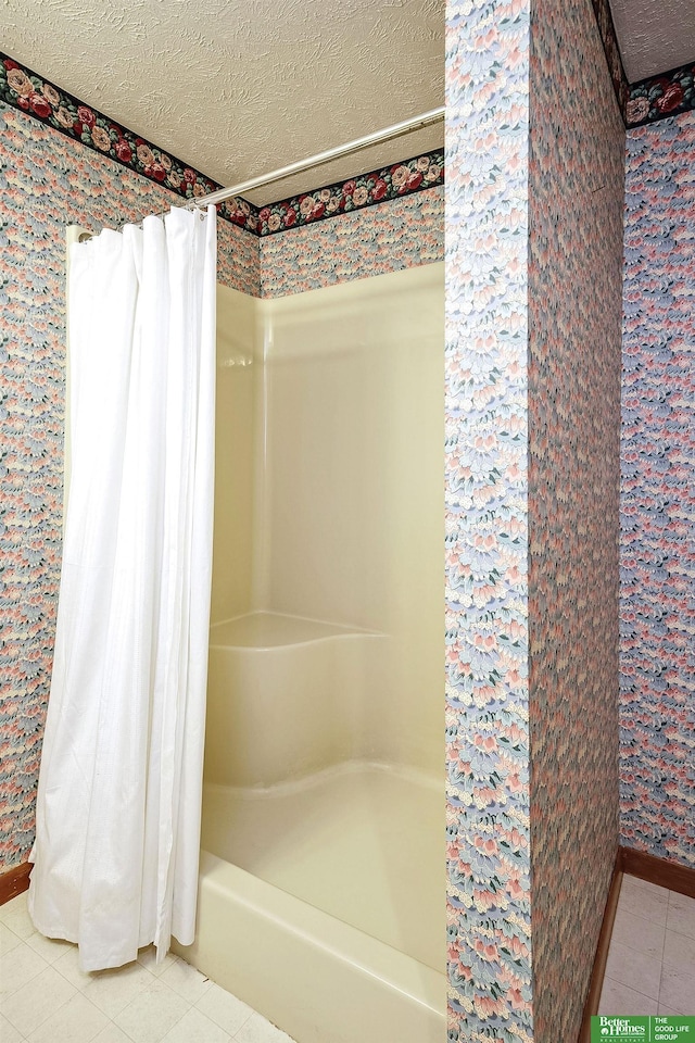 9706 N 51st St, Omaha, NE 68152 - bathroom with tile patterned floors, a textured ceiling, wallpapered walls, and baseboards