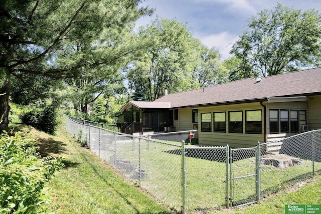 9706 N 51st St, Omaha, NE 68152 - back of house with a sunroom, a gate, and a shingled roof