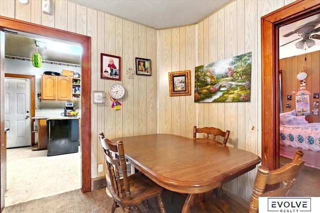 453 W 4th St, Wahoo, NE 68066 - dining area with wood walls, light carpet, and a ceiling fan