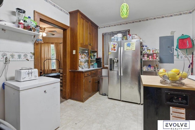 453 W 4th St, Wahoo, NE 68066 - kitchen with stainless steel fridge, electric panel, brown cabinets, refrigerator, and light countertops