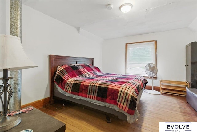 453 W 4th St, Wahoo, NE 68066 - bedroom with wood finished floors, lofted ceiling, and baseboards