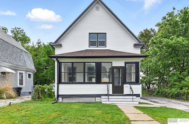 2909 N 26th St, Omaha, NE 68111 - view of front of property with a sunroom, a front yard, and entry steps