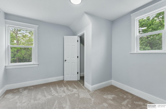 2909 N 26th St, Omaha, NE 68111 - unfurnished room featuring plenty of natural light, carpet floors, and baseboards
