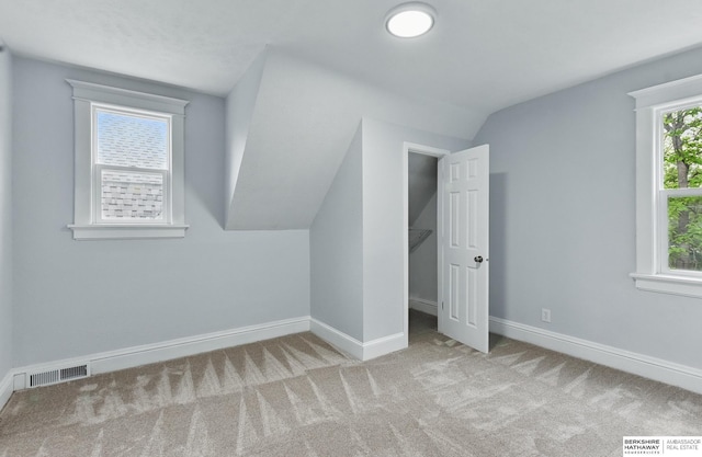 2909 N 26th St, Omaha, NE 68111 - additional living space with lofted ceiling, baseboards, and carpet floors