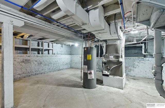 2909 N 26th St, Omaha, NE 68111 - unfinished basement featuring water heater, brick wall, and heating unit