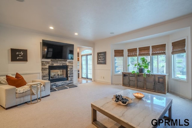 15931 Yates St, Omaha, NE 68116 - carpeted living room featuring crown molding, a stone fireplace, and recessed lighting