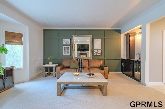 15931 Yates St, Omaha, NE 68116 - living room with ornamental molding, light carpet, beverage cooler, baseboards, and a decorative wall