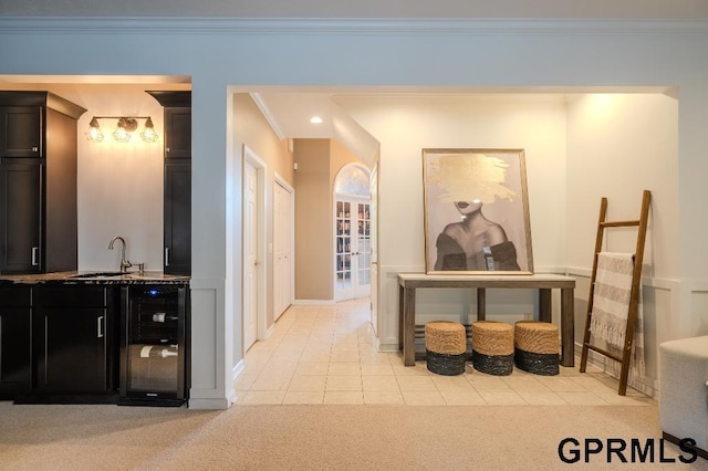 15931 Yates St, Omaha, NE 68116 - hall with beverage cooler, a sink, crown molding, light colored carpet, and baseboards