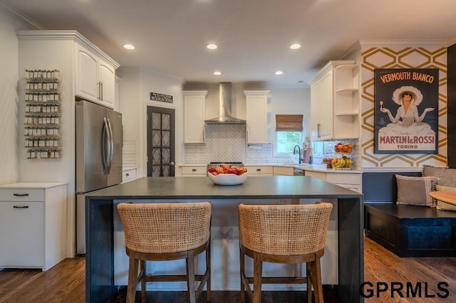 15931 Yates St, Omaha, NE 68116 - kitchen featuring wall chimney range hood, freestanding refrigerator, a sink, ornamental molding, and dark wood-type flooring
