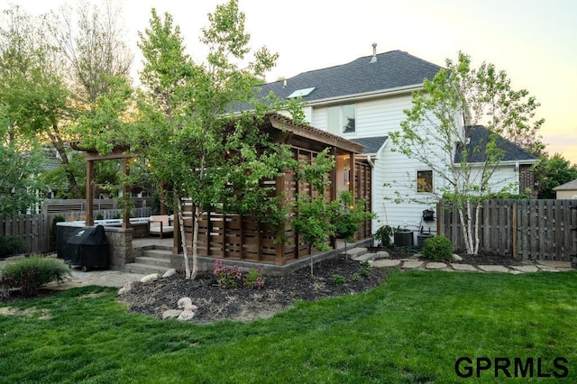 15931 Yates St, Omaha, NE 68116 - rear view of house featuring outdoor lounge area, central AC, a patio area, and a garden