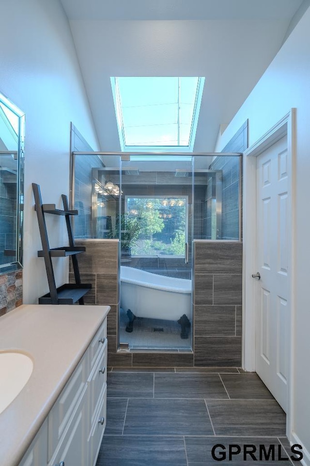 15931 Yates St, Omaha, NE 68116 - bathroom featuring a skylight, vanity, a soaking tub, tiled shower, and lofted ceiling