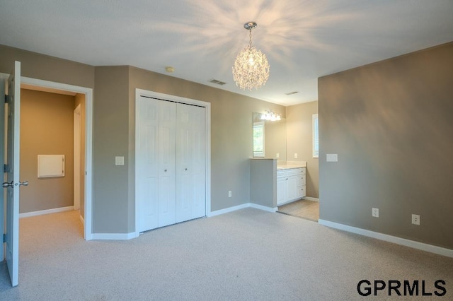 15931 Yates St, Omaha, NE 68116 - unfurnished bedroom with a chandelier, baseboards, light carpet, and a closet