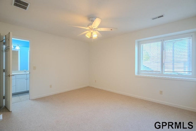 15931 Yates St, Omaha, NE 68116 - empty room with light carpet, a ceiling fan, baseboards, and a sink