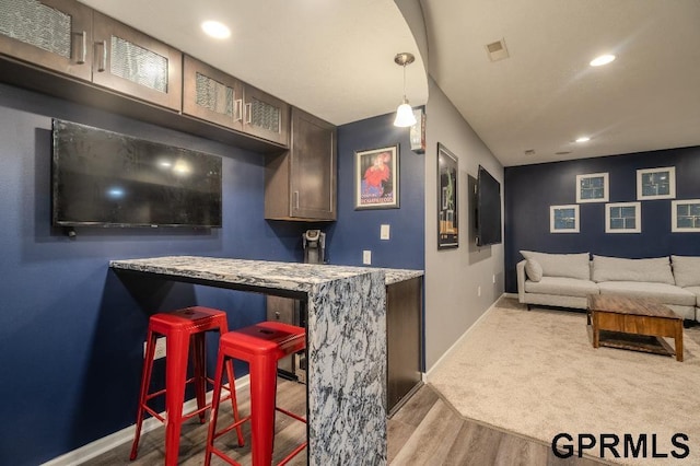 15931 Yates St, Omaha, NE 68116 - indoor wet bar with wood finished floors, baseboards, recessed lighting, and decorative light fixtures