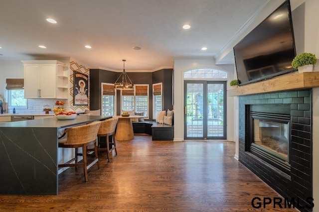15931 Yates St, Omaha, NE 68116 - kitchen featuring open shelves, white cabinets, dark wood finished floors, crown molding, and tasteful backsplash
