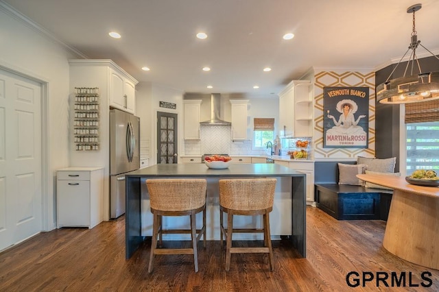 15931 Yates St, Omaha, NE 68116 - kitchen with freestanding refrigerator, wall chimney range hood, decorative backsplash, white cabinetry, and open shelves