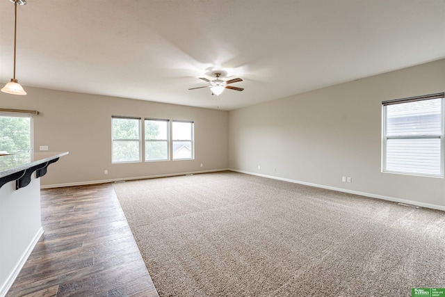 4604 Hansen Ave, Papillion, NE 68133 - unfurnished living room with ceiling fan, baseboards, and dark wood-type flooring