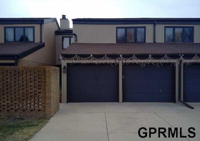 2919 Park Place Dr, Lincoln, NE 68506 - multi unit property featuring a garage, concrete driveway, and a chimney