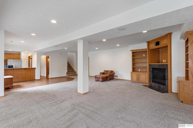 14906 Hanover St, Bennington, NE 68007 - living area with recessed lighting, light colored carpet, baseboards, stairs, and a premium fireplace
