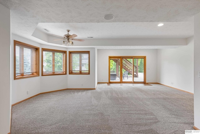 14906 Hanover St, Bennington, NE 68007 - spare room featuring baseboards, carpet flooring, a ceiling fan, healthy amount of natural light, and a textured ceiling