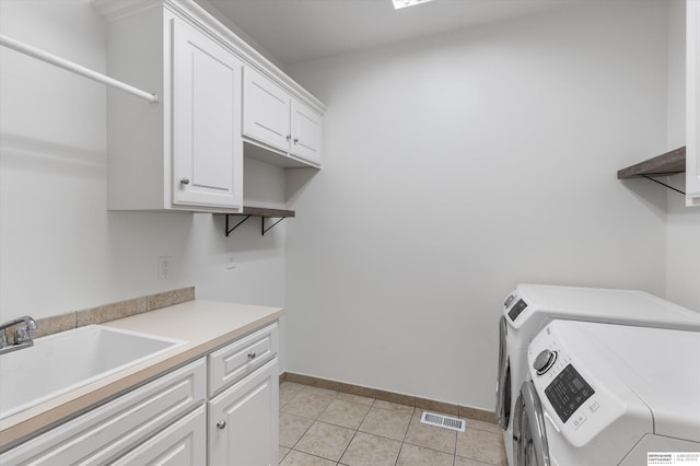 14906 Hanover St, Bennington, NE 68007 - laundry room featuring washing machine and dryer, cabinet space, light tile patterned floors, and baseboards