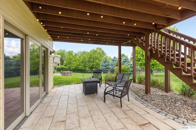 14906 Hanover St, Bennington, NE 68007 - fenced backyard featuring stairway, a patio, and an outdoor fire pit