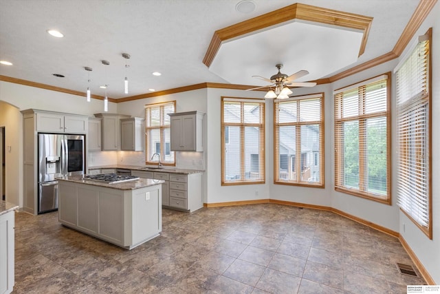 14906 Hanover St, Bennington, NE 68007 - kitchen with stainless steel appliances, a sink, healthy amount of natural light, a ceiling fan, and crown molding