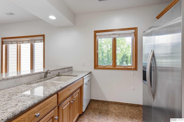 14906 Hanover St, Bennington, NE 68007 - kitchen featuring stainless steel fridge, a sink, baseboards, light stone counters, and recessed lighting