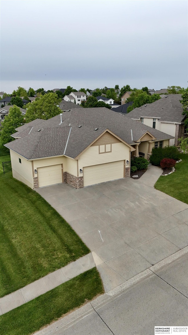 14906 Hanover St, Bennington, NE 68007 - view of front facade with a garage, concrete driveway, a front yard, and a residential view