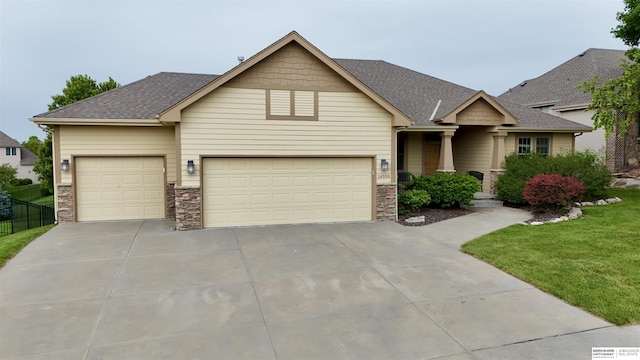 14906 Hanover St, Bennington, NE 68007 - craftsman inspired home with concrete driveway, roof with shingles, a garage, and stone siding