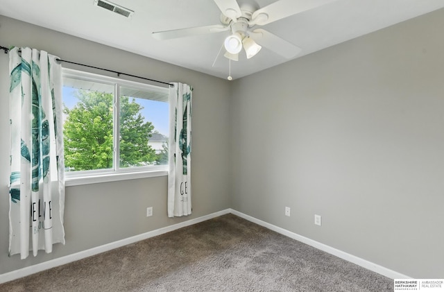 1502 Florence Blvd, Omaha, NE 68110 - unfurnished room featuring dark colored carpet, baseboards, and a ceiling fan