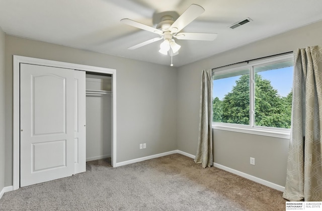 1502 Florence Blvd, Omaha, NE 68110 - unfurnished bedroom featuring carpet flooring, baseboards, a closet, and a ceiling fan