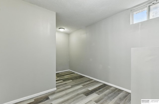 1502 Florence Blvd, Omaha, NE 68110 - unfurnished room featuring wood finished floors, baseboards, and a textured ceiling