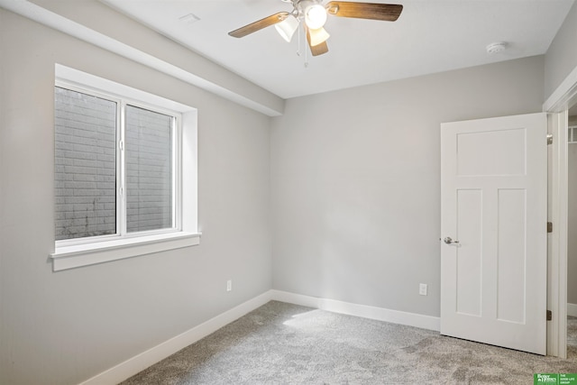 2273 N 38th Ave, Omaha, NE 68111 - empty room featuring light carpet, a ceiling fan, a smoke detector, and baseboards