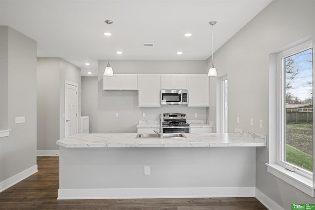 2273 N 38th Ave, Omaha, NE 68111 - kitchen featuring stainless steel appliances, white cabinets, recessed lighting, dark wood-type flooring, and baseboards