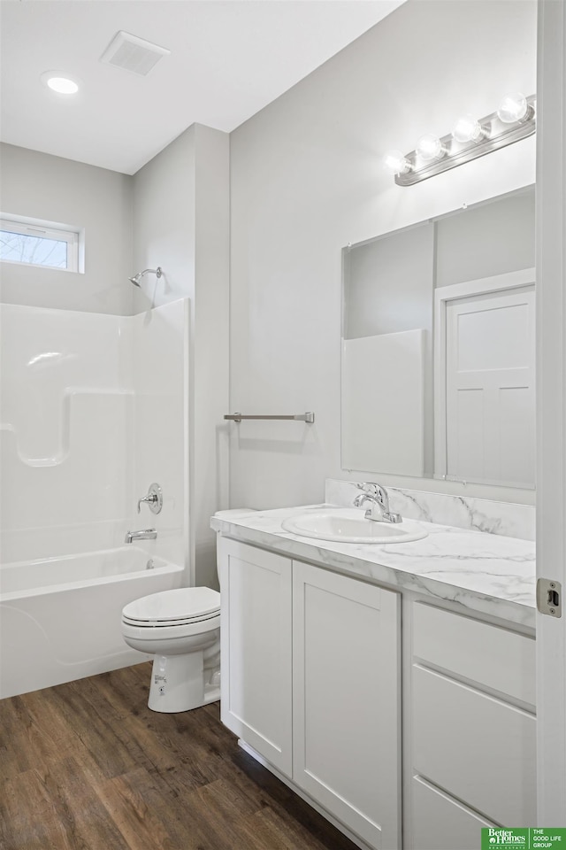 2273 N 38th Ave, Omaha, NE 68111 - bathroom featuring toilet, vanity, wood finished floors, shower / bath combination, and recessed lighting
