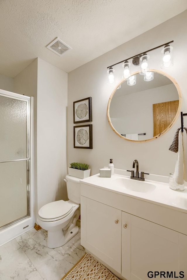 15614 Redwood St, Omaha, NE 68136 - bathroom featuring vanity, toilet, marble look tiles, a shower stall, and a textured ceiling