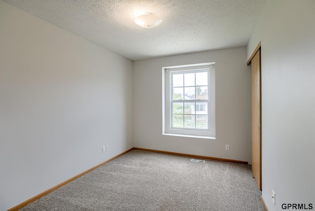 15614 Redwood St, Omaha, NE 68136 - empty room featuring carpet flooring, a textured ceiling, and baseboards