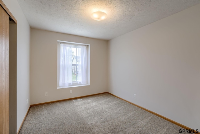 15614 Redwood St, Omaha, NE 68136 - spare room with light colored carpet, a textured ceiling, and baseboards