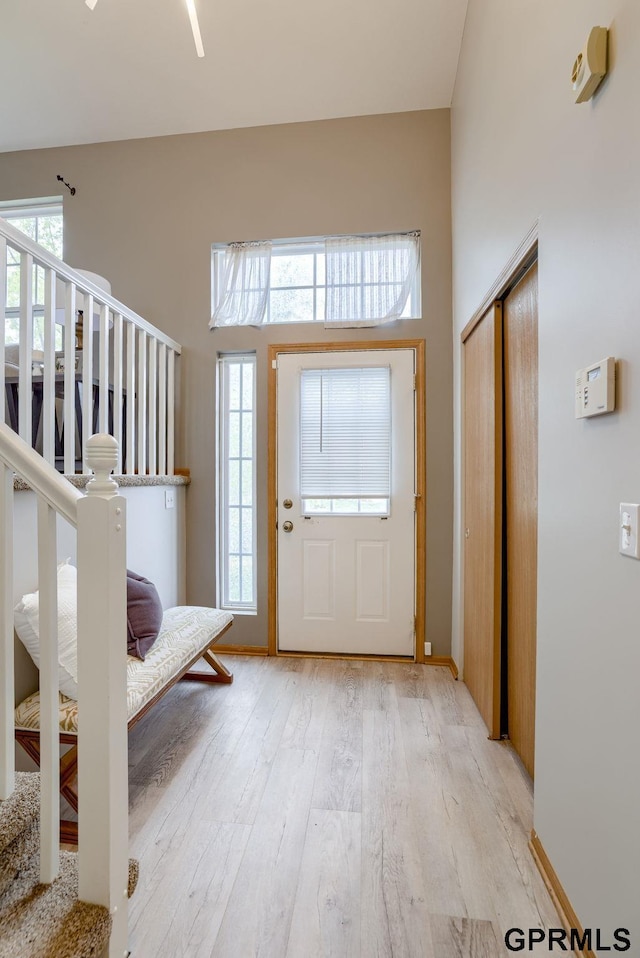 15614 Redwood St, Omaha, NE 68136 - entryway featuring light wood finished floors, plenty of natural light, stairway, and a towering ceiling