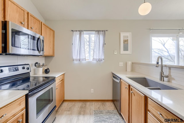 15614 Redwood St, Omaha, NE 68136 - kitchen featuring appliances with stainless steel finishes, a sink, light wood finished floors, light countertops, and lofted ceiling