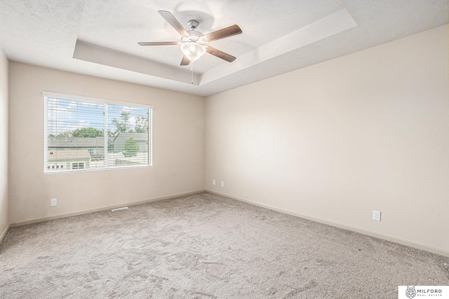 7423 N 139th Ave, Omaha, NE 68142 - empty room with a raised ceiling, carpet floors, and ceiling fan