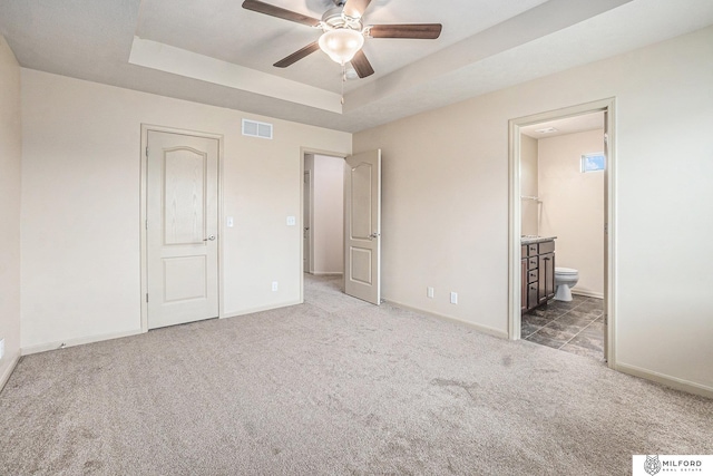 7423 N 139th Ave, Omaha, NE 68142 - unfurnished bedroom featuring carpet floors, a raised ceiling, ensuite bathroom, baseboards, and ceiling fan