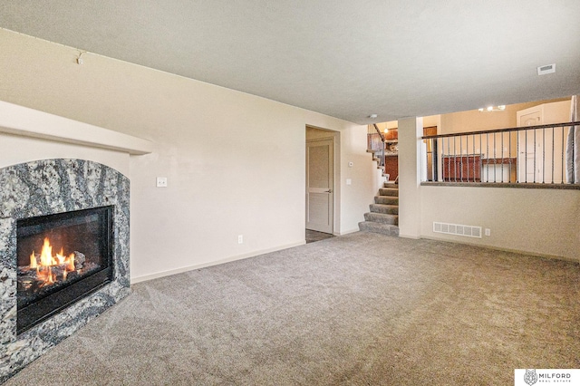 7423 N 139th Ave, Omaha, NE 68142 - unfurnished living room with a high end fireplace, carpet floors, and stairs