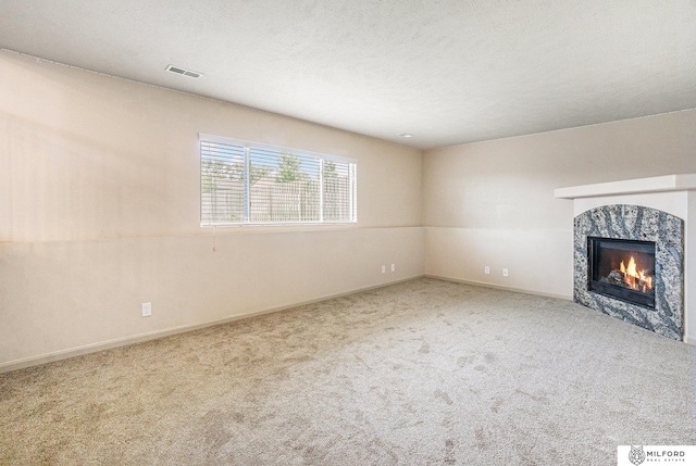 7423 N 139th Ave, Omaha, NE 68142 - unfurnished living room featuring carpet, a glass covered fireplace, baseboards, and a textured ceiling