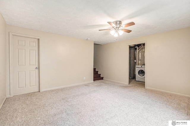 7423 N 139th Ave, Omaha, NE 68142 - empty room with washer / dryer, ceiling fan, stairway, light colored carpet, and baseboards