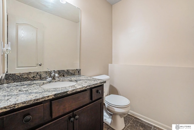 7423 N 139th Ave, Omaha, NE 68142 - bathroom with toilet, vanity, and baseboards