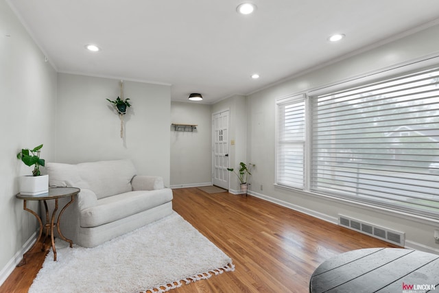 3920 Randolph St, Lincoln, NE 68510 - living area with ornamental molding, wood finished floors, baseboards, and recessed lighting